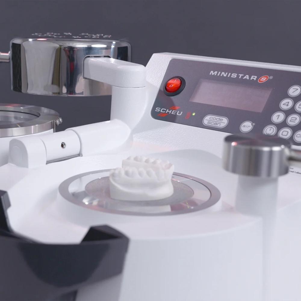 MiniSTAR S® positive pressure thermal forming machine on dark gray background